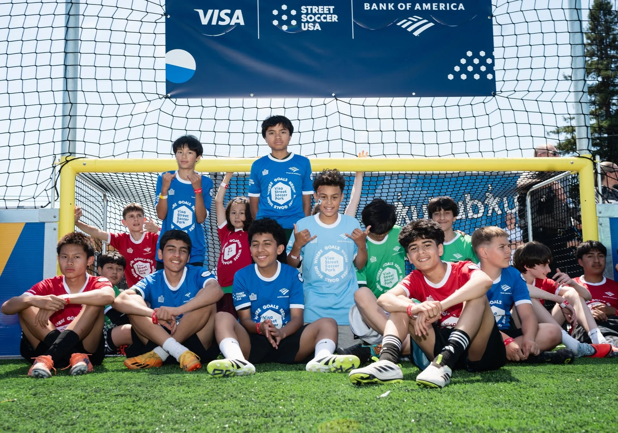 Street Soccer USA players gathered in front of a small-sided goal